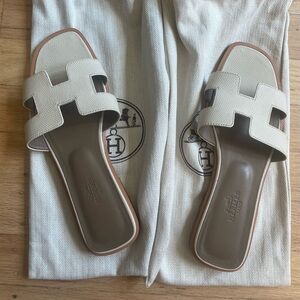 Hermes Oran Sandal in Box calfskin with iconic "H" cut-out.